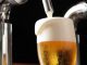 Japanese draft beer dispenser pouring lager with a creamy foam head