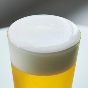 Close-up of stable white foam on a freshly poured golden lager